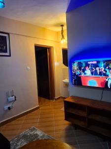 a living room with a flat screen tv on a wall at Baraka Stay,Kenol,Gitura,Murang'a in Gitura