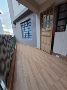 a room with a wooden floor and a door at Baraka Stay,Kenol,Gitura,Murang'a in Gitura