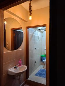 a bathroom with a sink and a toilet and a mirror at Baraka Stay,Kenol,Gitura,Murang'a in Gitura +6 photos