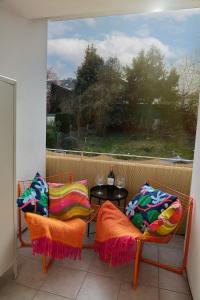 a balcony with two chairs and a table and a window at 2 OG HbF Wuppertal DomusKushal in Wuppertal