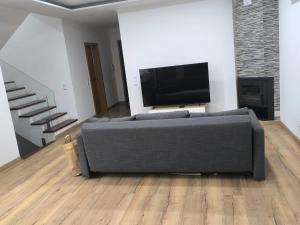 a living room with a couch and a flat screen tv at Residência SB in Odivelas
