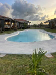 a large swimming pool in front of a building at Amigos do Vento Chalés e Kite Point in Touros +58 photos