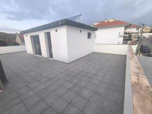 a white building with a large parking lot at Residência SB in Odivelas