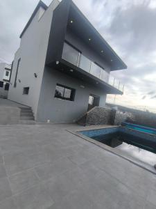 a house with a swimming pool in front of it at Residência SB in Odivelas
