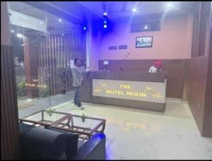 a man standing at a counter in a lobby at Hotel moon in Pāonta Sāhib