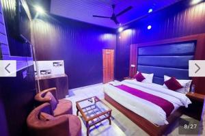 a bedroom with a large bed and a chair at Hotel moon in Pāonta Sāhib