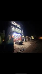 a car parked in front of a building at night at Hotel moon in Pāonta Sāhib