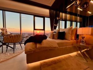 a bedroom with a bed with a view of a city at Sky Suite 22 Hanza Tower in Szczecin