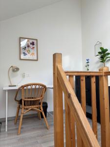 a wooden staircase with a chair and a desk at L'Aile de Fontainebleau in Fontainebleau