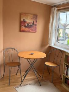 a table and two chairs in a room at Apartment to Düsseldorf - near Airport DUS - Trade Fair - Arena in Düsseldorf