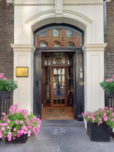 a door to a building with flowers in front of it at The Marker Hotel in London +30 photos
