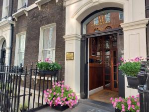 a door to a building with flowers in front of it at The Marker Hotel in London