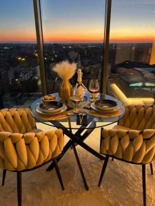 a table with two chairs and wine glasses on top of a building at Sky Suite 22 Hanza Tower in Szczecin