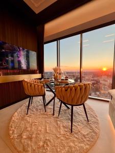 a dining room with a table and chairs and a view at Sky Suite 22 Hanza Tower in Szczecin