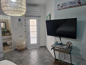 a living room with a flat screen tv on a wall at Studio Caroline in Eilat