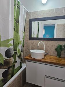 a bathroom with a sink and a mirror at Studio Caroline in Eilat