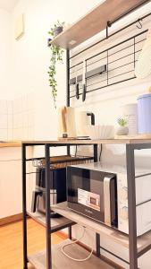 a kitchen with a counter with a microwave on a table at Apartment in Leipzig in Leipzig +5 photos