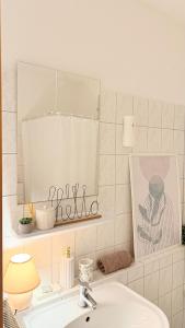 a bathroom with a sink and a mirror and a mirror at Apartment in Leipzig in Leipzig