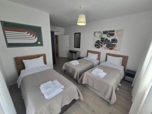 a room with two beds with towels on them at Shkodra Harmony Residences in Shkodër +56 photos