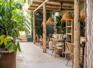 a restaurant with tables and chairs and plants at Casa Con Destino in Jalón