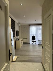 a room with a hallway with a living room at Grand Teatro Hotel in Ganja