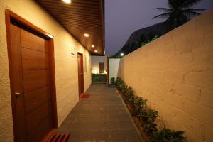 a hallway of a building with a door and a wall at Misty Garden Retreat in Nandigunda