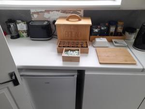 a kitchen counter with a box of donuts on it at Greenview in Didcot +31 photos
