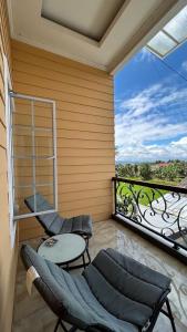 a room with a balcony with a table and chairs at Villa Bali Rice Field in Sukaraja