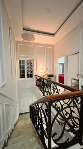 a staircase in a white room with a stair railing at Villa Bali Rice Field in Sukaraja