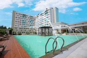 a large swimming pool in front of a building at 727 Anabelle Residence at Marina Spatial Condominium in Dumaguete