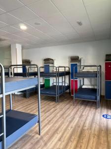 a room with several bunk beds in it at Albergue Alfonso II in Melide