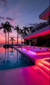 a pool with pink lights in front of a building at Villa Alfa Kosta in Cairo