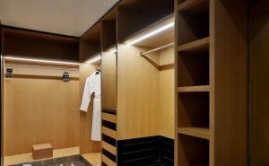 a walk in closet with wooden walls and shelves at Villa Alfa Kosta in Cairo
