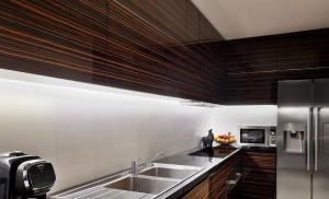 a kitchen with a sink and a refrigerator at Villa Alfa Kosta in Cairo