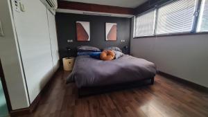 a bedroom with a bed with a teddy bear on it at Residenza 402 in Ivrea