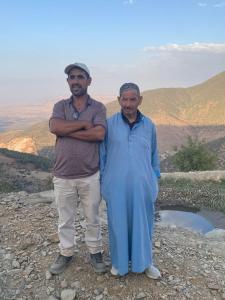 two men standing on top of a mountain at Sidi hssain in Marrakesh
