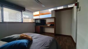 a bedroom with a bed with blue pillows on it at Residenza 402 in Ivrea