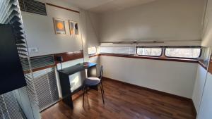 a small room with a desk and a chair in it at Residenza 402 in Ivrea +3 photos