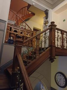 a spiral staircase with a clock in a house at B&B Chatelet Cremers in Verviers +118 photos