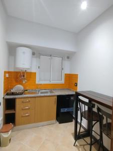 a kitchen with a sink and a counter top at Hôtel Dar Farhat in Tunis