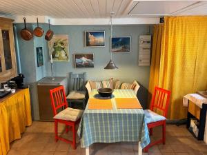 a dining room with a table and chairs and a kitchen at pallisgaard B&B in Struer +22 photos