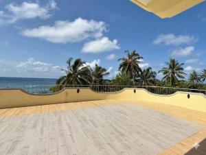 a balcony with a view of the ocean at Noah Private Beach House in Himmafushi