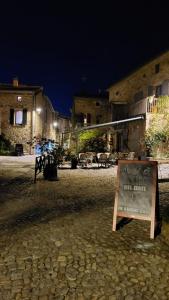 a sign in the middle of a courtyard at night at La chambre secrète in Aiguèze