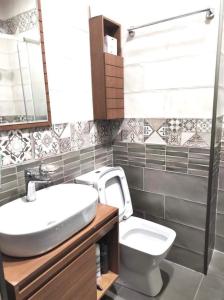 a bathroom with a sink and a toilet at Apartamenti Panorama in Kobuleti +28 photos