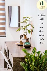 a dining room table with plants on it at DeHa Homestay in Hue +13 photos
