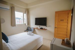 a bedroom with a bed and a flat screen tv at 綠島 棲間民宿 Green Island Roost B&B in Green Island +40 photos