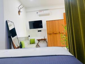 a bedroom with a bed and a flat screen tv at Sea Path Villa - Dikwella in Dickwella
