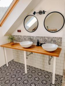 a bathroom with two sinks and a mirror at Ta Chalupa in Prostřední Bečva +45 photos