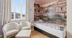 a bedroom with a bed and a painting on the wall at Guesthouse Kiljan in Blönduós +51 photos