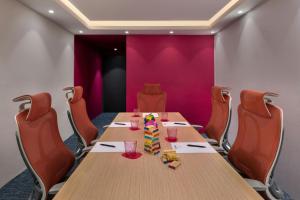 a conference room with a wooden table and chairs at Moxy Kathmandu in Kathmandu +54 photos